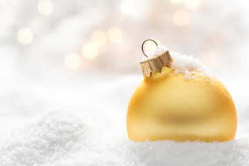 Golden christmas ball on snow