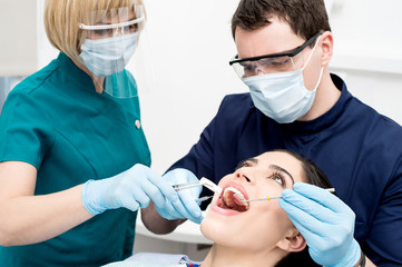 Dentist examining gums of patient