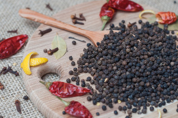 black pepper on wooden spoon