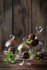 Chocolate sweets with nuts, mint and cacao on the vintage table