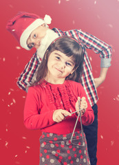 Christmas concept with brother and sister singing christmas carols