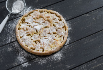 Apple pie on a dark wooden surface