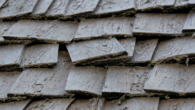 Wooden shingles on the wooden log house. The shingles can be found on the rooftop of the log house