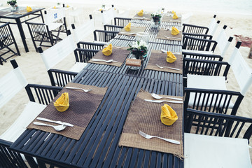 Fototapeta na wymiar Served table at the sea shore on tropical beach