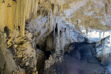 / Stalactites and stalagmites in a cave in Antiparos island in Greece. 