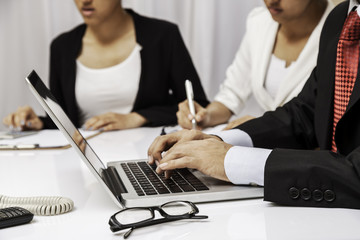 three business people working and discussing in the office