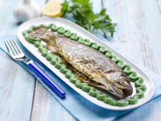 trout with spinach cream decoration,  selective focus