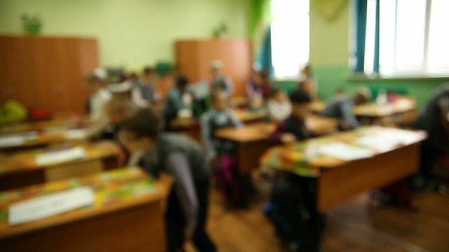 blurred background group of kids in classroom at a school desk is lesson in school