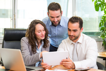 Group of business associates working together at the office