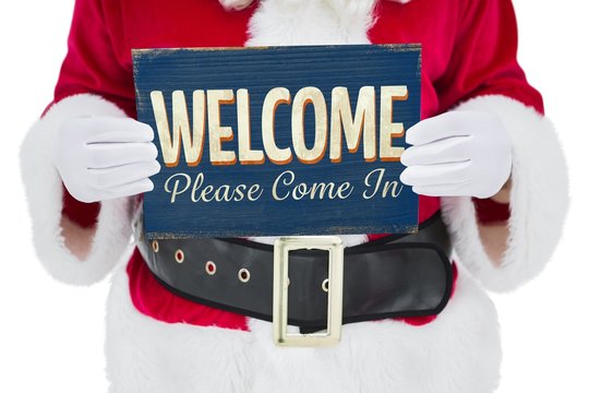 Composite image of mid section of santa claus holding page