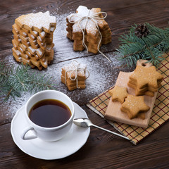 Gingerbread on wooden background with a cup of coffee
