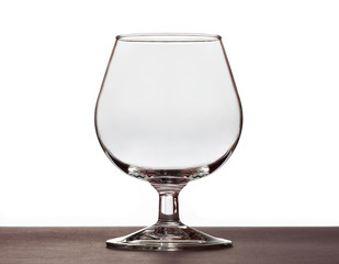 Empty cognac glass standing on the table.