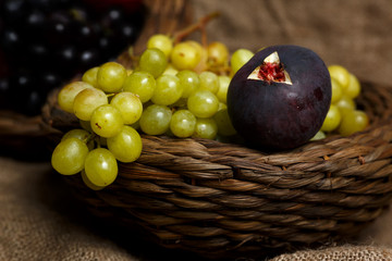 Still life of bunch of grapes,figs and plums