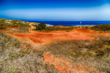 red path on the rocky beach
