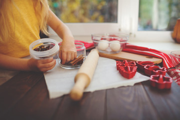 Happy little child baking Christmas cookies at home