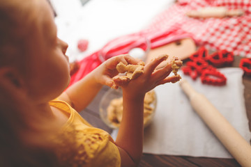 Obraz premium Happy little child baking Christmas cookies at home