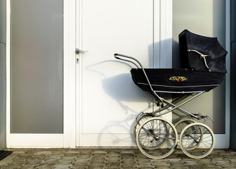 Fototapeta na wymiar Retro style stroller baby carriage outdoors