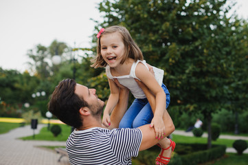 Dad playing with his daughter in park