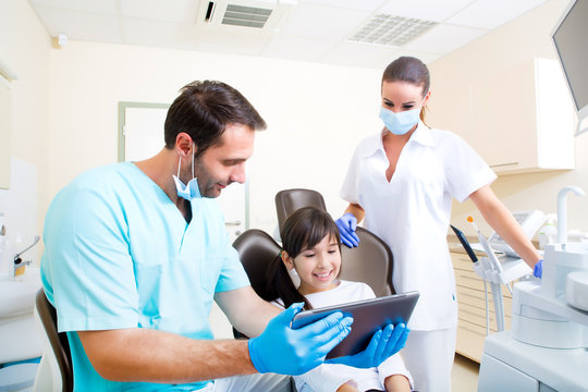 Dentist with a little girl and a Tablet PC.