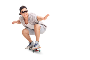 Young joyful skater riding a skateboard