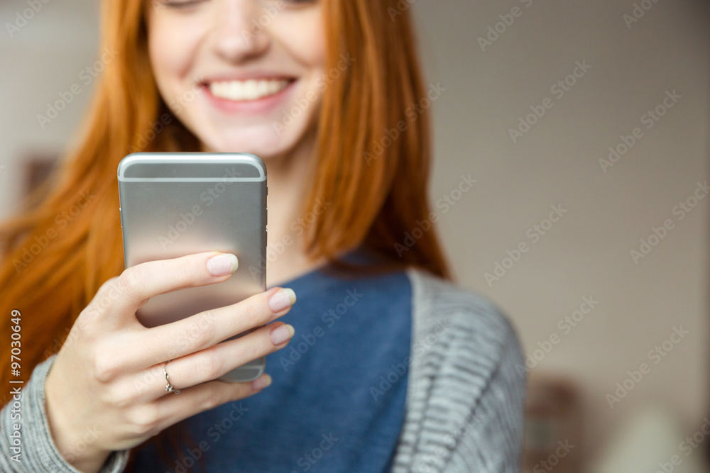 Canvas Prints redhead woman using smartphone