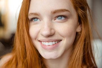 Smiling redhead woman looking up