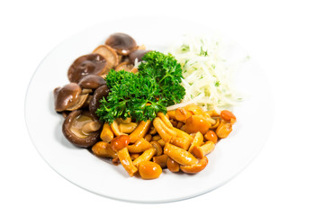 Marinated mushrooms with herbs and onions on a white plate