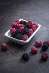 colorful jelly candies in bowl on wooden table