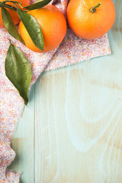 Natural sweet clementines on rustic table from above