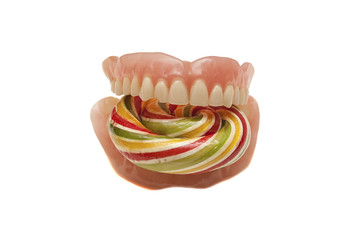 Candy inserted into the denture isolated on white background