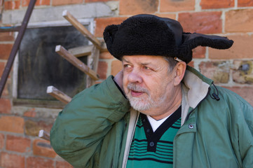 Outdoor portrait of a bearded Ukrainian peasant with sly look