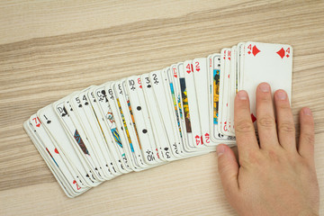 Hand touches deck of cards