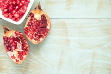 Pomegranates over grunge wooden background
