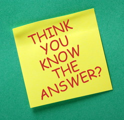 The phrase Think You Know The Answer in red text on a yellow sticky note posted on a green notice...