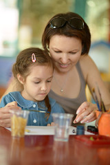 Girl painting with  mother