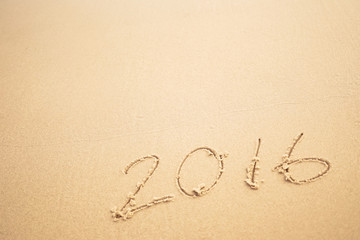 2016 text on the beach for new year concept background
