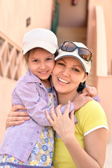 Mother with  daughter near hotel