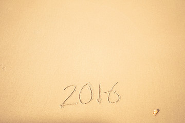 Fototapeta na wymiar 2016 text on the beach for new year concept background 