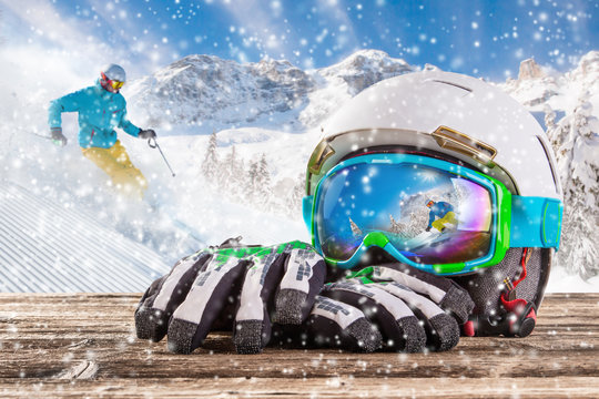 Colorful ski glasses, gloves and helmet
