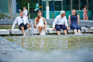 Business people splashing water with their feet