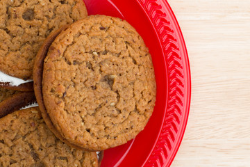 Oatmeal crème cookies on a red plate