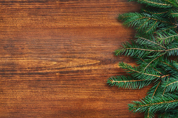 Christmas fir tree border on a wooden background