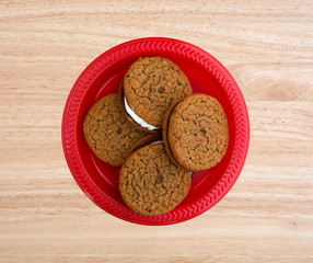 Oatmeal crème cookies on a red plate