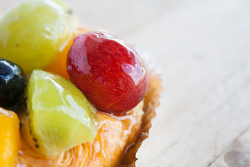close up danish pastry with fruit on wood table