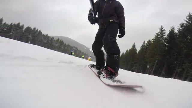 Snowboarding rotation on the surface with selfie stick