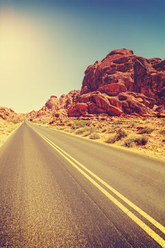 Vintage toned desert highway, travel concept, USA