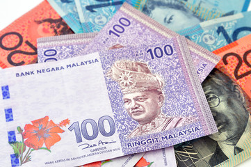 A close-up photograph of Australian dollars and Malaysia's ringgit Malaysia currency.