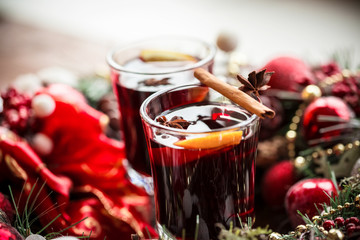 Christmas hot mulled wine with spices on a wooden table. The idea for creating greeting cards