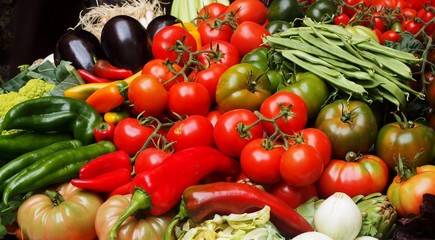 colorful groceries of tomatoes, red chili, , egg plants, onions, and cherries