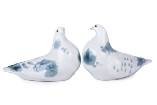 Porcelain figurines of pigeons, isolated on white
